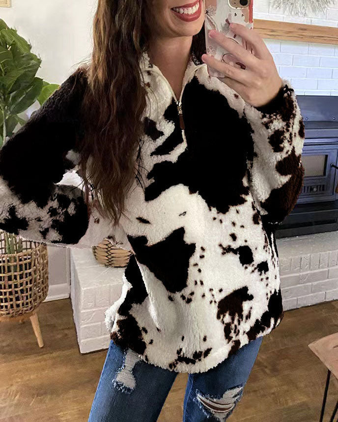 Cozy white, brown, and black cow-print pullover with a zip-up collar