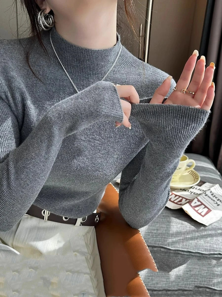 Suéter de mujer de cuello alto acanalado y manga larga con abertura para el pulgar, de color liso