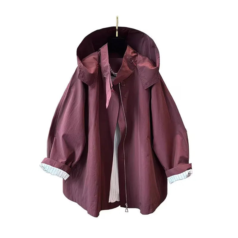 Loose-fitting mid-length women's jacket with stand-up collar, buttons, and hood