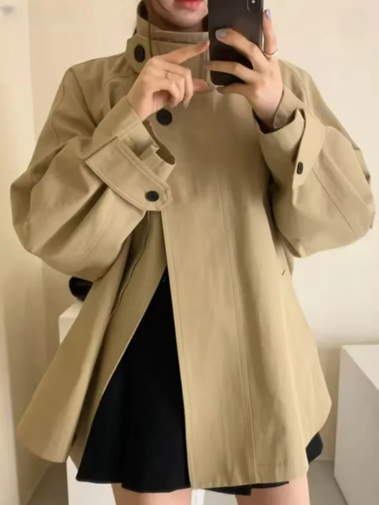 Loose-fitting mid-length women's jacket with stand-up collar, buttons, and hood