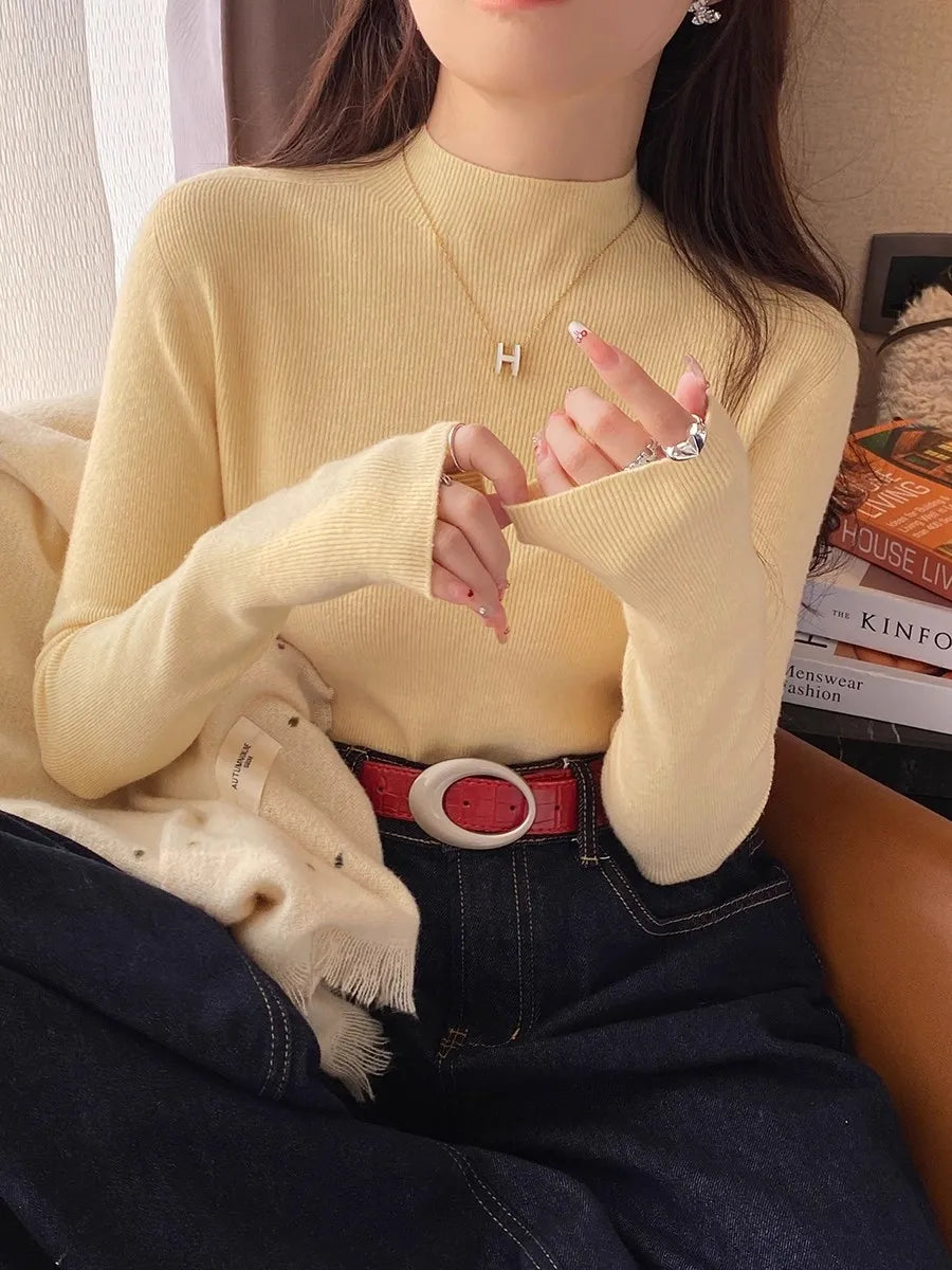 Suéter de mujer de cuello alto acanalado y manga larga con abertura para el pulgar, de color liso