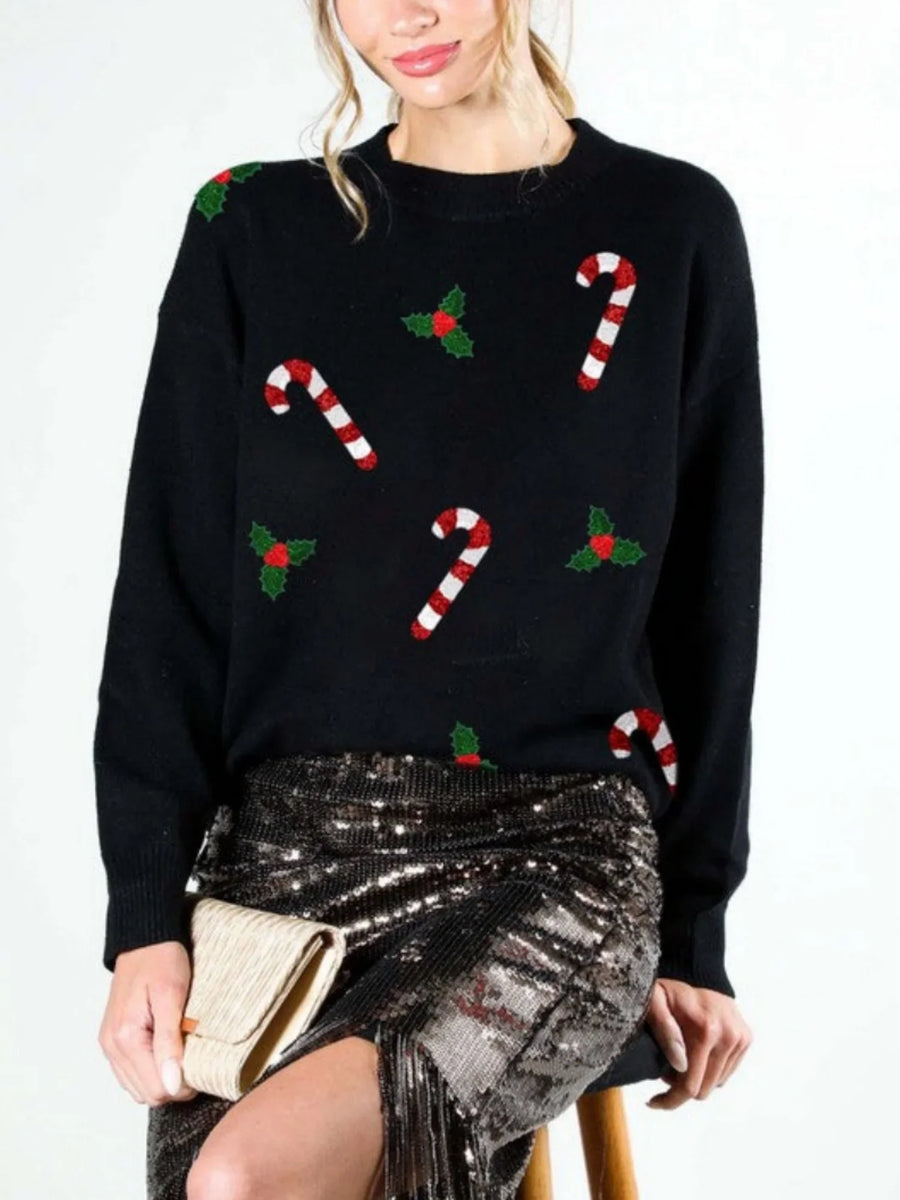 Green women's Christmas sweater with candy cane and holly designs