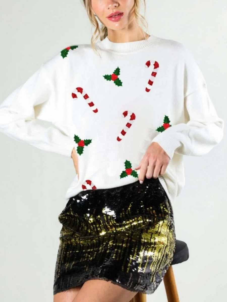 Green women's Christmas sweater with candy cane and holly designs