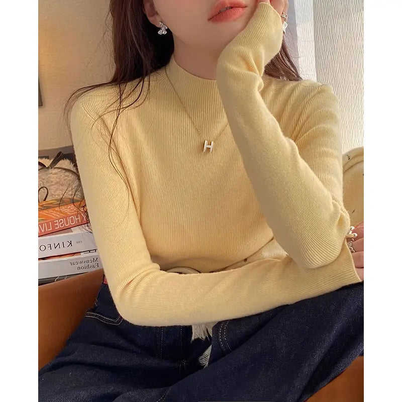 Suéter de mujer de cuello alto acanalado y manga larga con abertura para el pulgar, de color liso