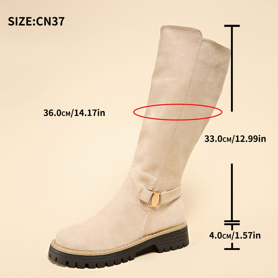 Women's black knee-high boots with suede-look finish, decorative buckle, and lug sole