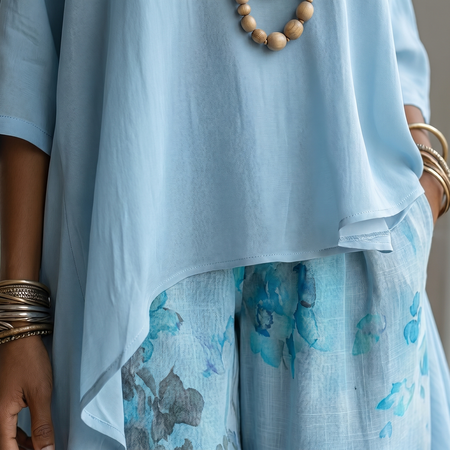 Sett med asymmetrisk bluse og ledig bukse med sennepsfarget trykk