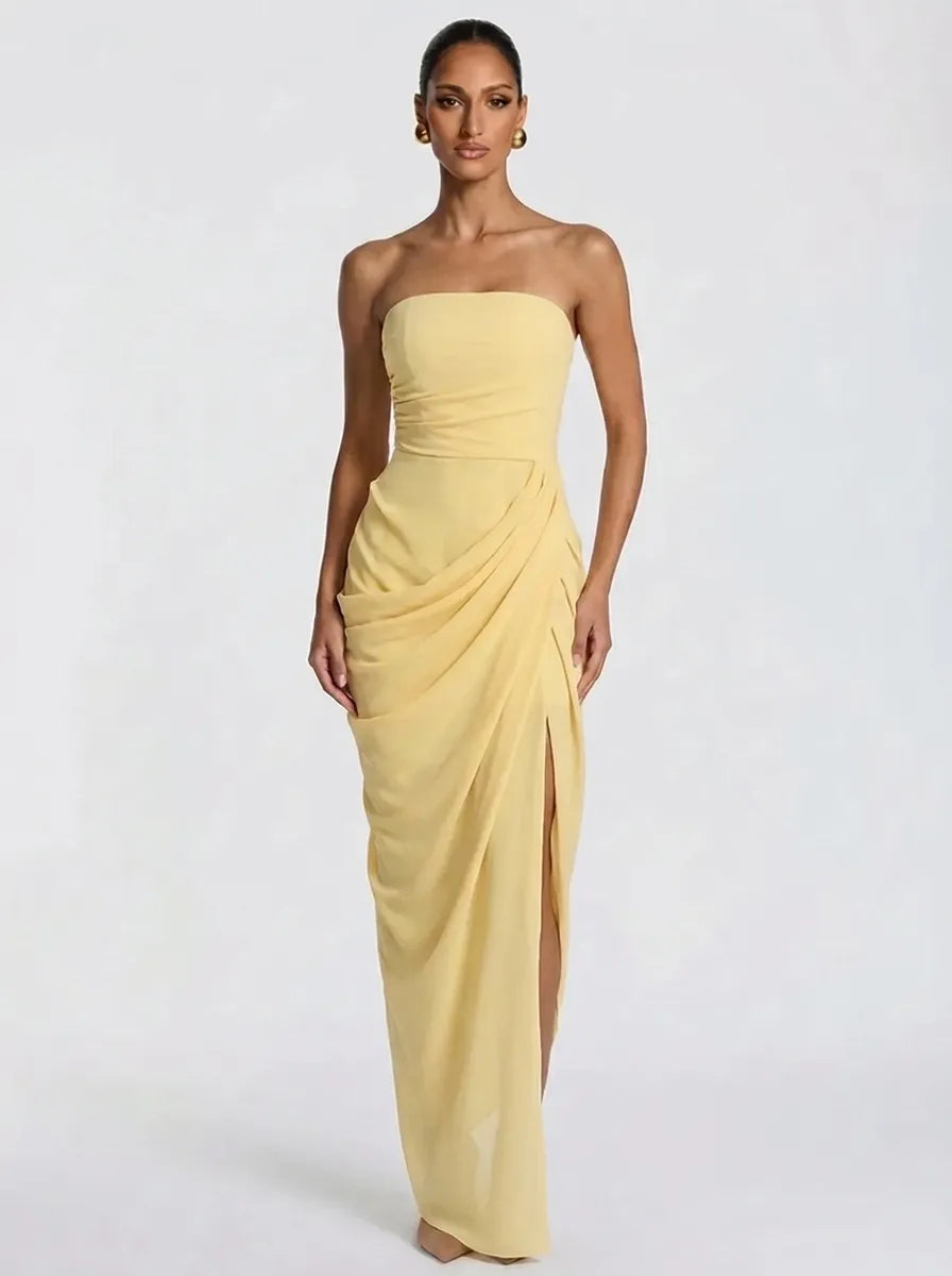 Women's pale yellow strapless pleated maxi dress with a slit