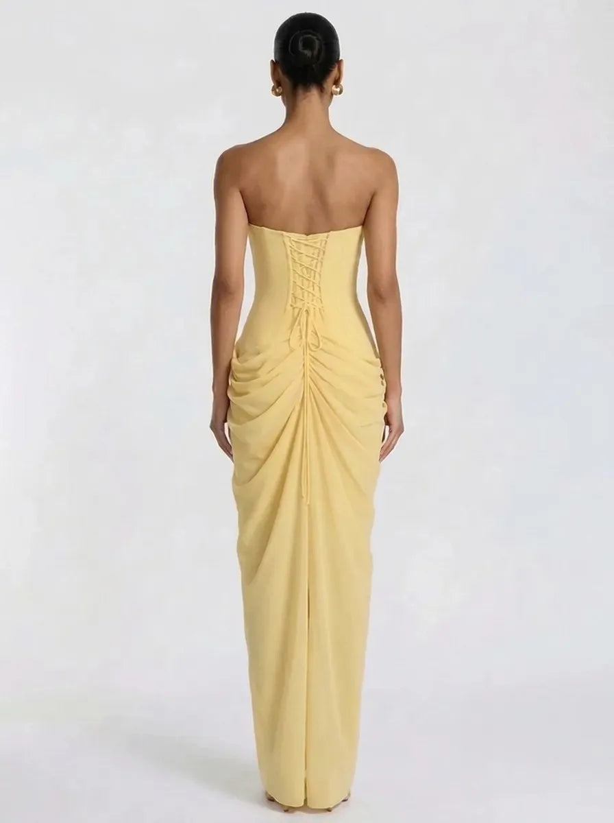 Women's pale yellow strapless pleated maxi dress with a slit