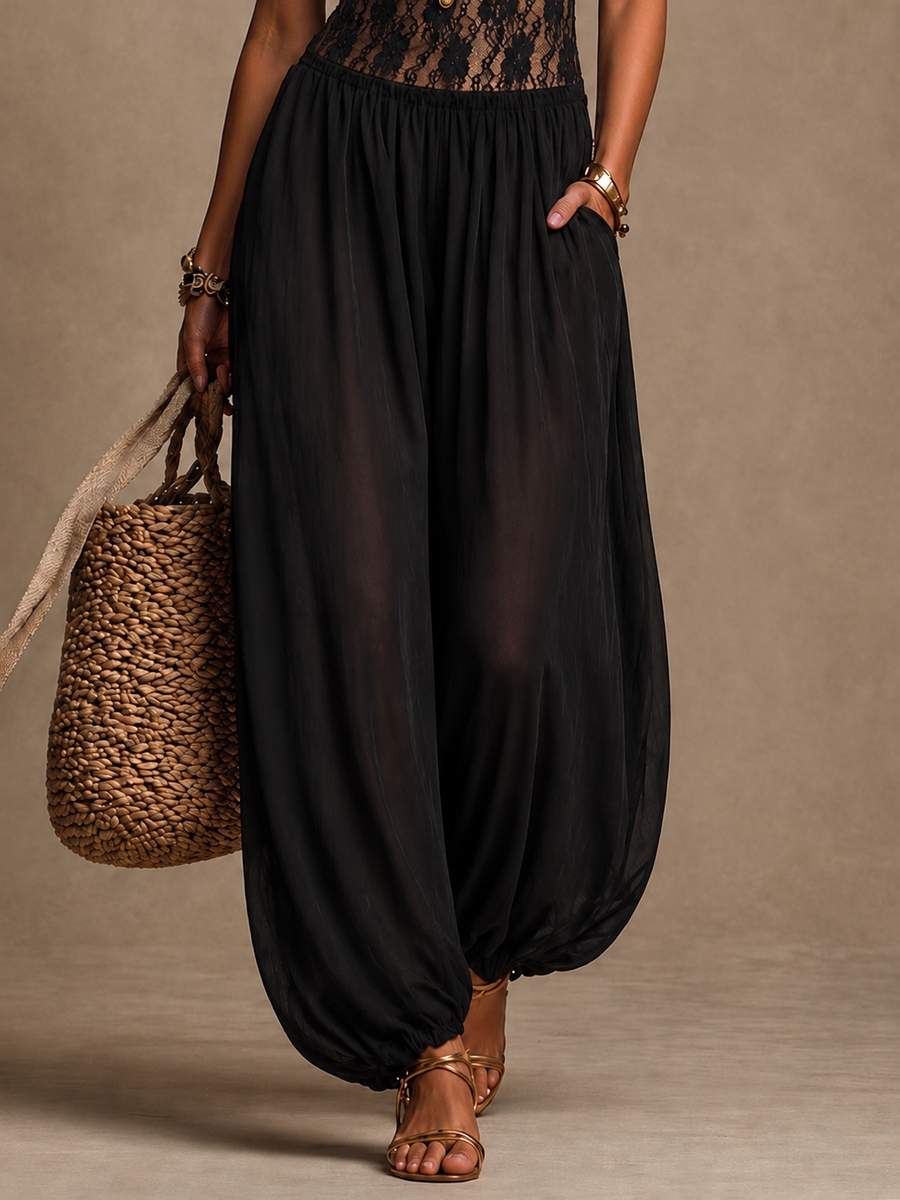 Zwarte damesjumpsuit met kanten bustier, soepelvallende harembroek