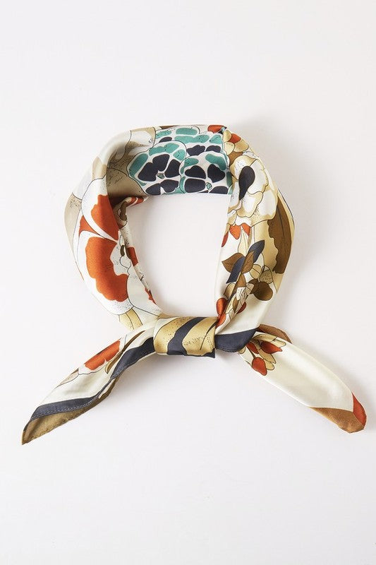 Square scarf with a floral pattern, bright colors, and a contrasting border