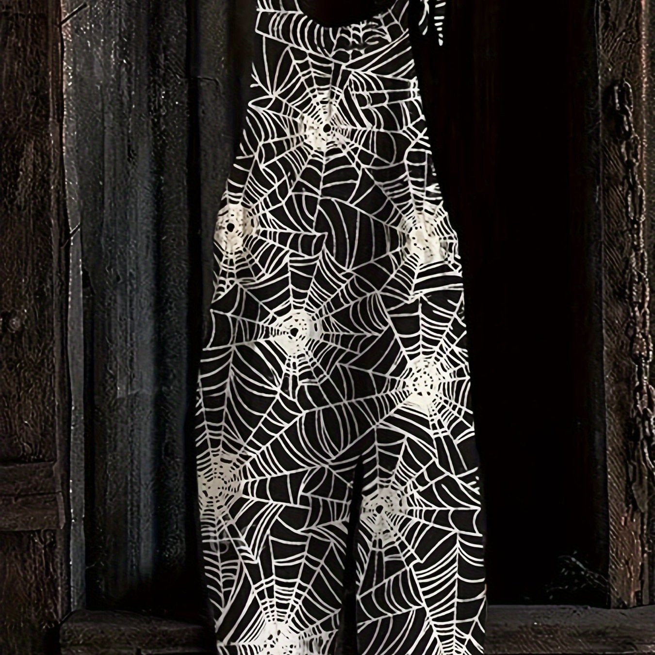 Combinaison pantalon femme noire à motif toile d'araignée bretelles fines