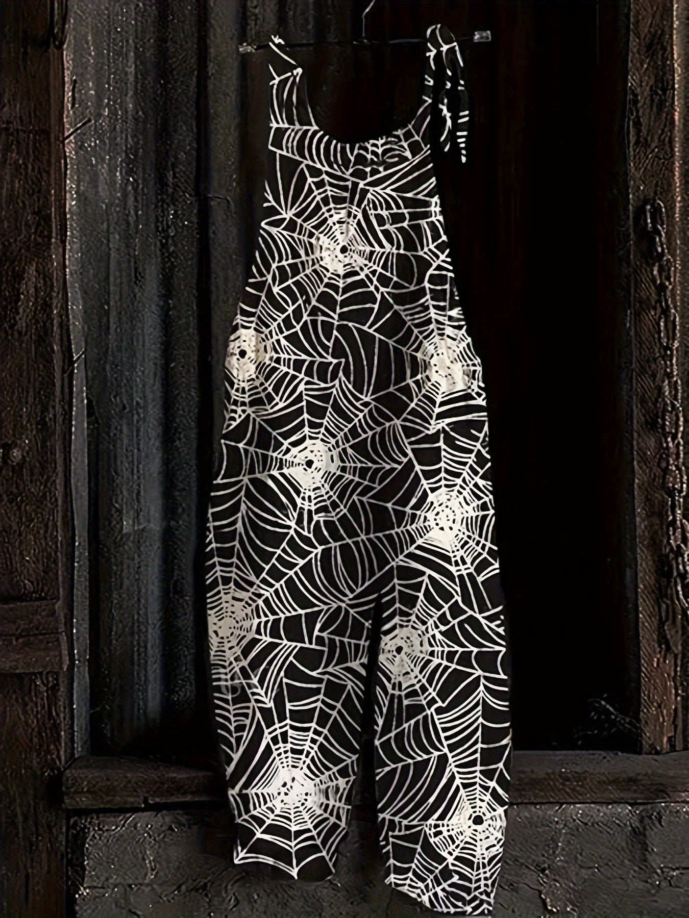 Combinaison pantalon femme noire à motif toile d'araignée bretelles fines