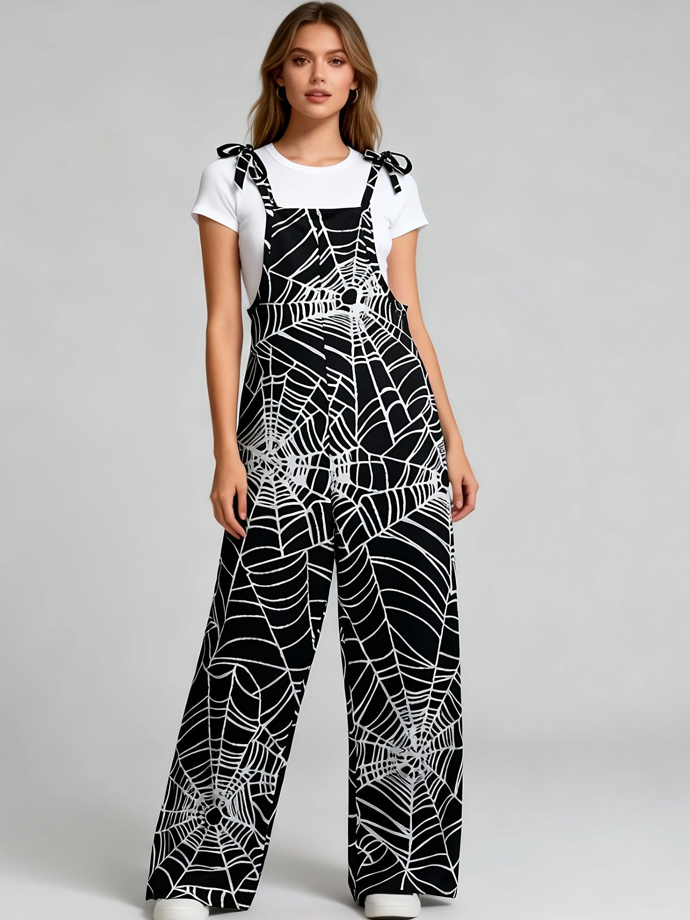 Combinaison pantalon femme noire à motif toile d'araignée bretelles fines