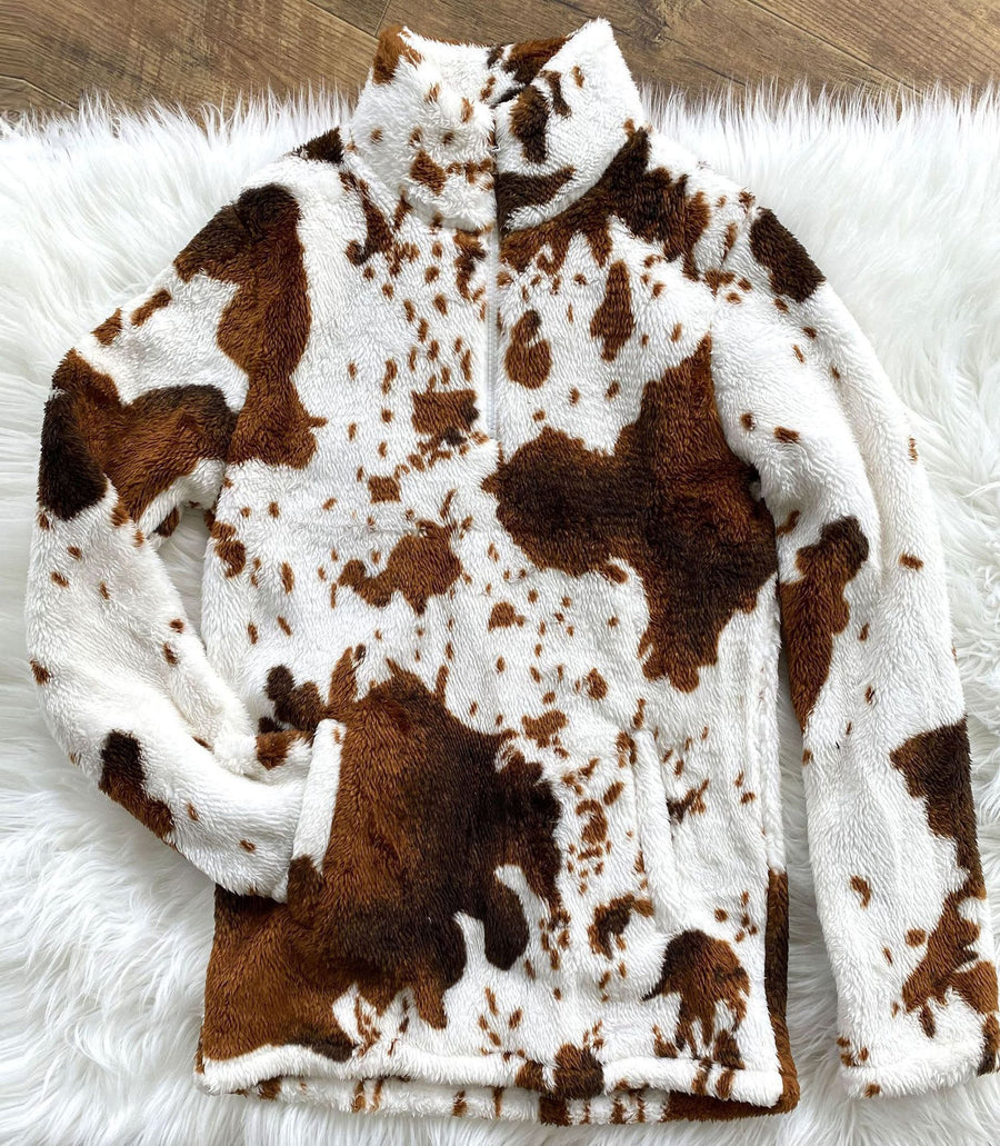 Cozy white, brown, and black cow-print pullover with a zip-up collar