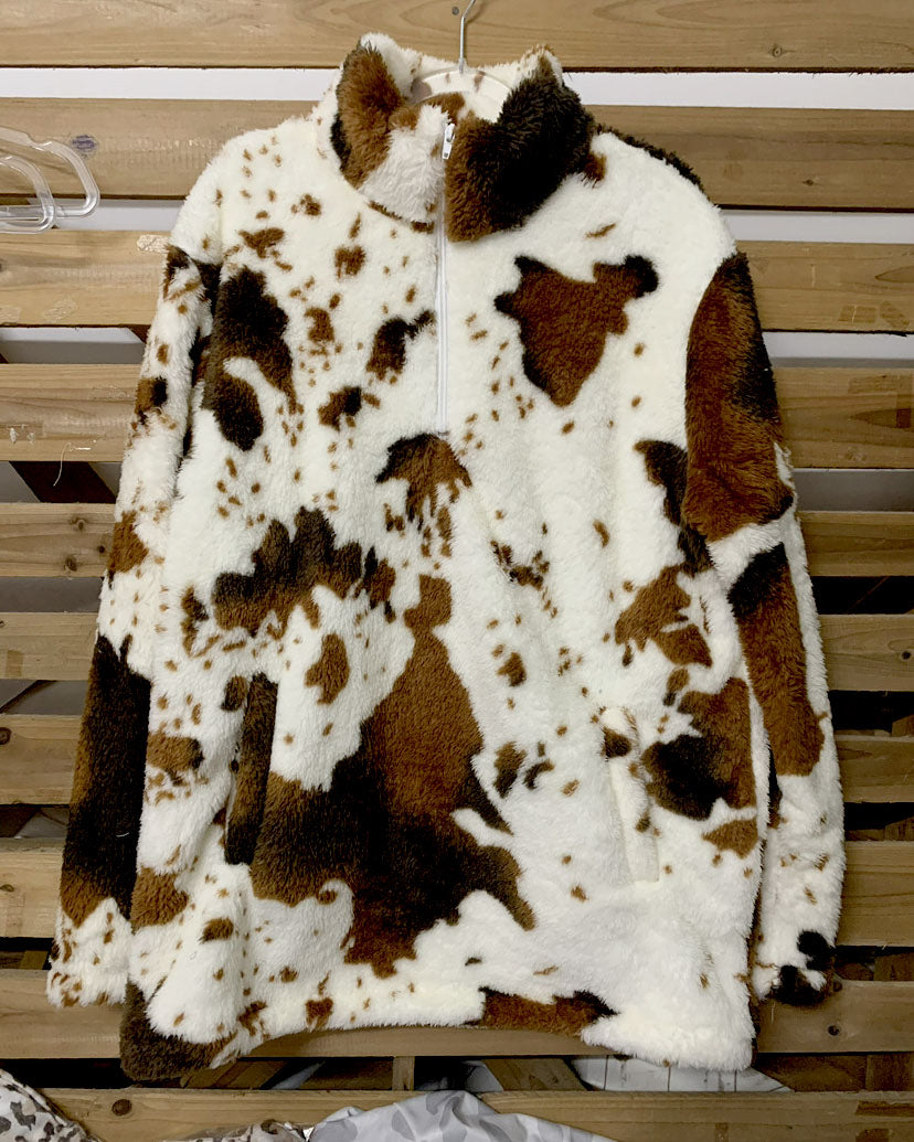Cozy white, brown, and black cow-print pullover with a zip-up collar