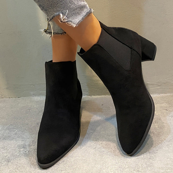 Women's black Chelsea boots with a square heel, pointed toe, and soft material