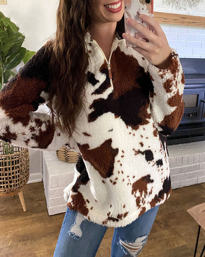 Cozy white, brown, and black cow-print pullover with a zip-up collar