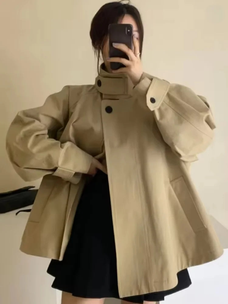 Loose-fitting mid-length women's jacket with stand-up collar, buttons, and hood