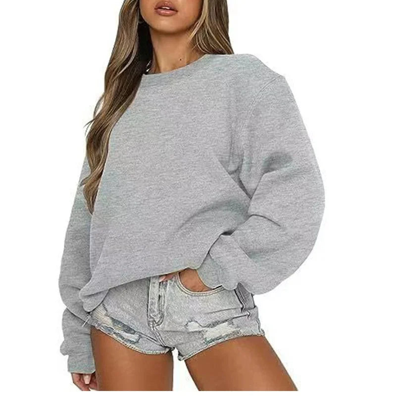 Ensfarvet, løstsiddende sweatshirt til kvinder med rund hals og lange ærmer