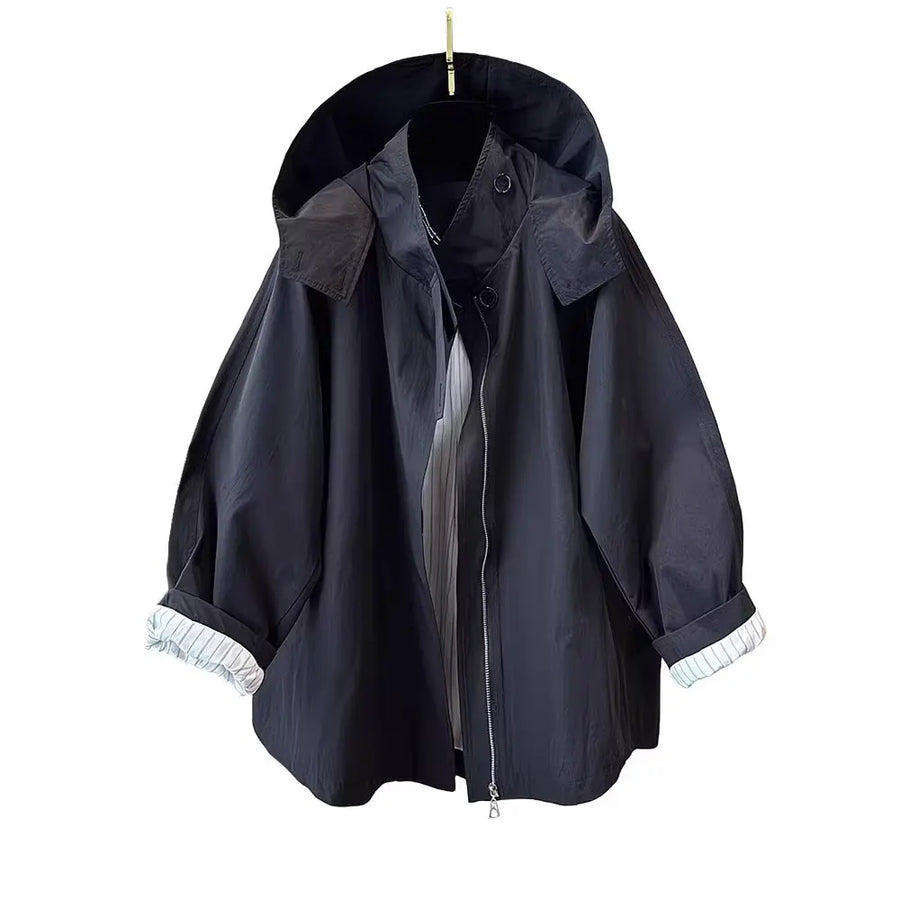 Loose-fitting mid-length women's jacket with stand-up collar, buttons, and hood