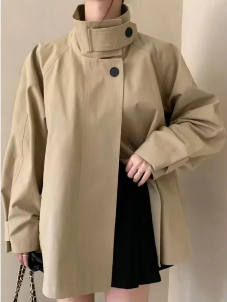 Loose-fitting mid-length women's jacket with stand-up collar, buttons, and hood