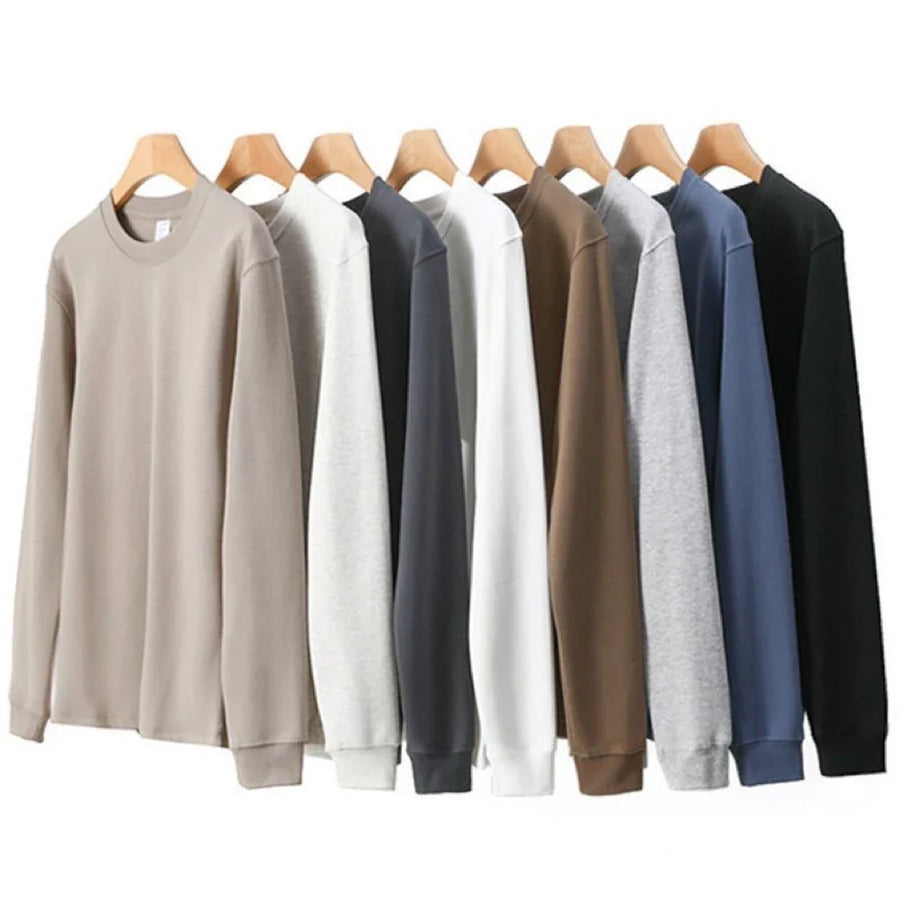 Avslappnad unisex sweatshirt med rund hals, långa ärmar och enfärgad design