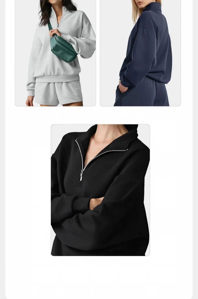 Sportssett for kvinner med sweatshirt med høy krage og glidelås samt lysegrå shorts