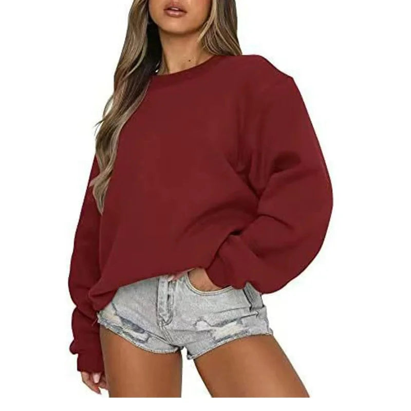 Ensfarvet, løstsiddende sweatshirt til kvinder med rund hals og lange ærmer