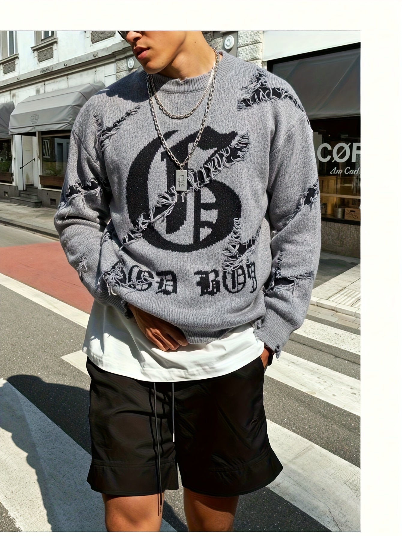Pull homme gris déchiré oversize avec motif graphique