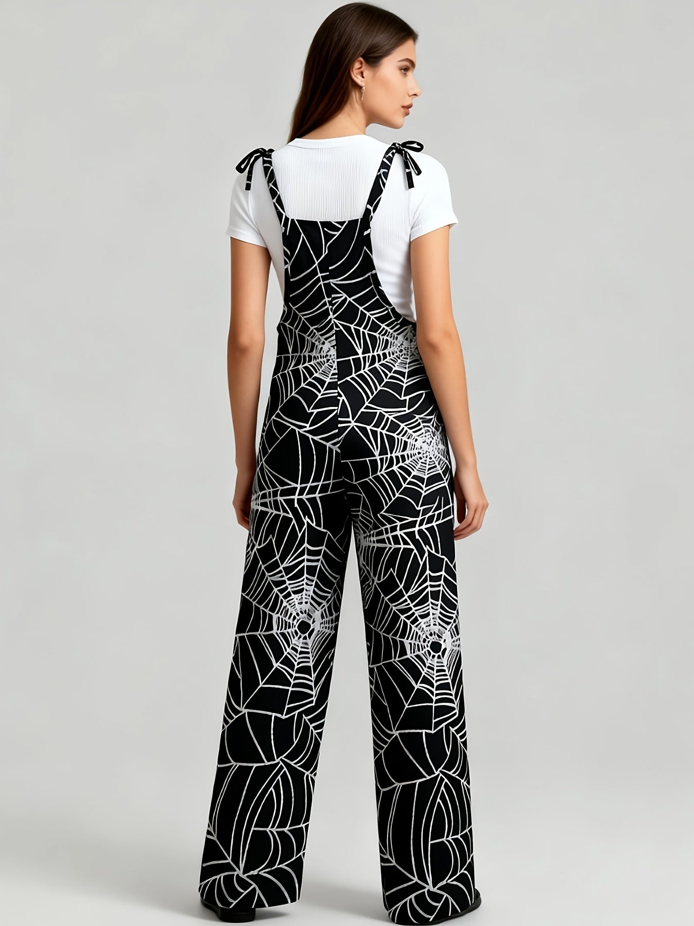 Combinaison pantalon femme noire à motif toile d'araignée bretelles fines